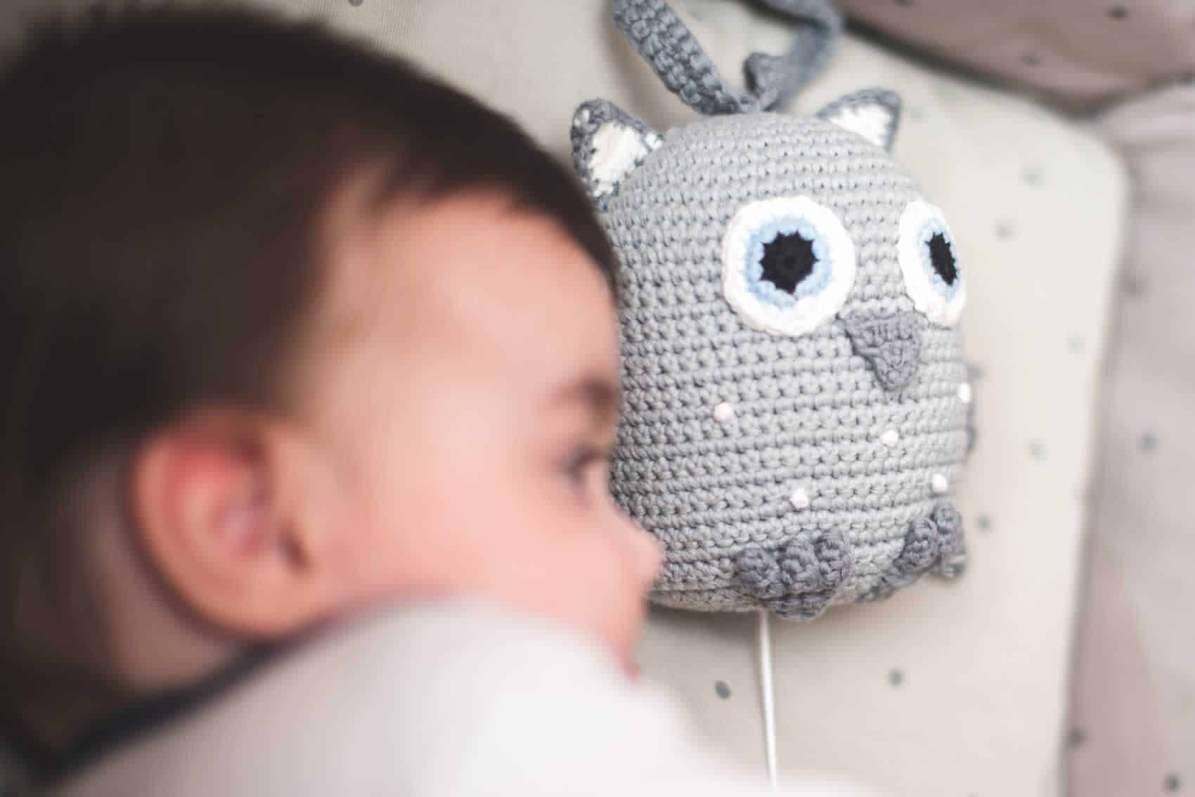 Schlafendes Baby im Kinderbettchen mit Eule-Spieluhr (Kategorie-Bild)